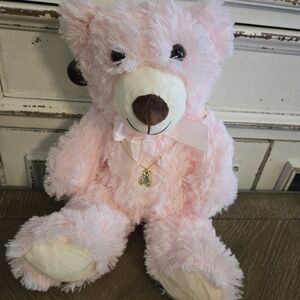 Pink plush bear with bear pendant necklace.